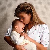 Picture of a mother kissing her infant on the forehead