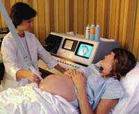 Picture of a physician performing an ultrasound on an expectant mother